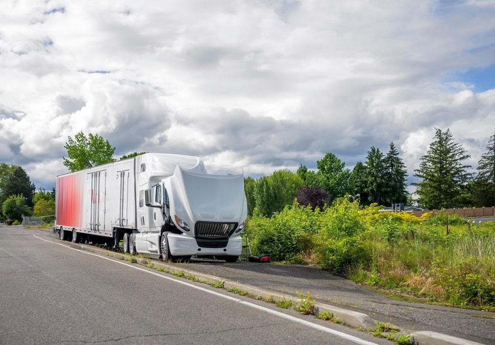 White transport truck broken down and requiring roadside assistance