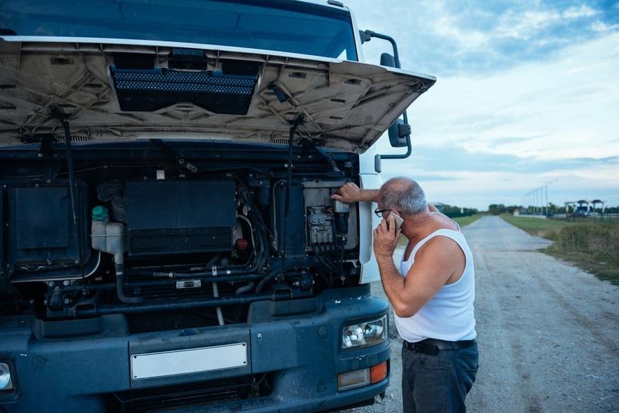 Man calling a diesel mechanic as his RV is broken down on the road