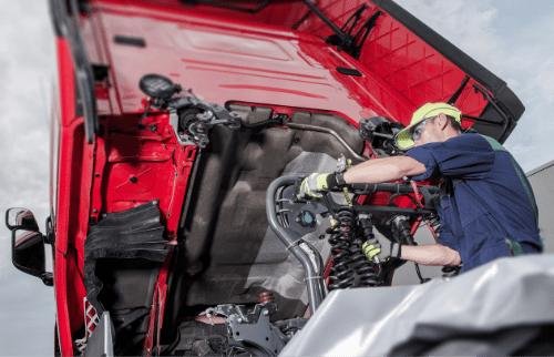 Mechanic providing a diagnostic for a large broken down truck