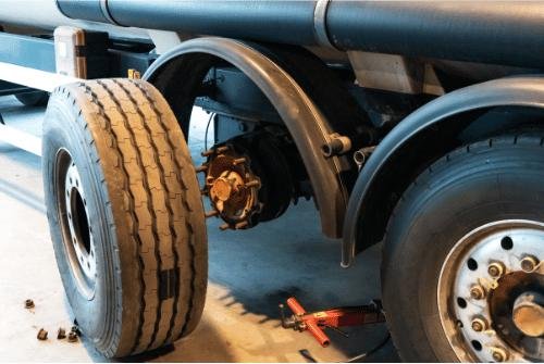 Big tire being changed on a transport truck in a local mechanic shop